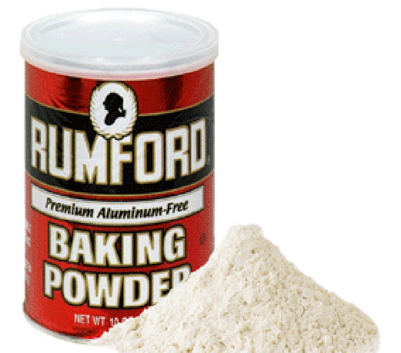 Commercial baking powder, tin and pile of the powder