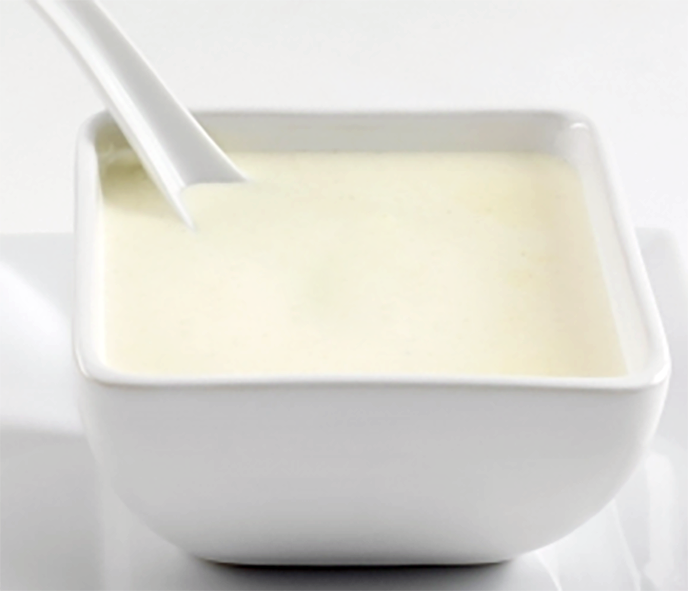 Bechamel sauce in a square bowl
