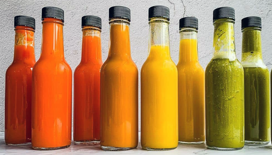 A range of bottled hot sauces of different colours