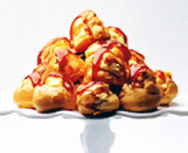 Choux pastry buns drizzled with caramel