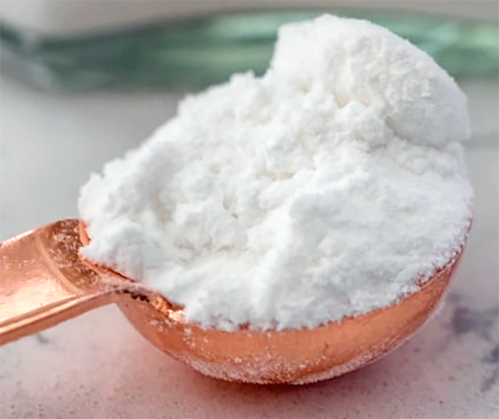 Powdered cream of tartar on a measuring spoon