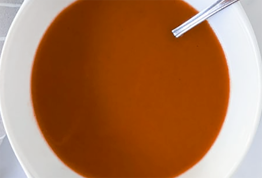Espagnole sauce in a white bowl