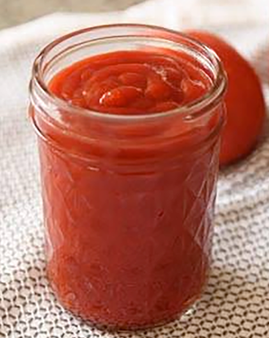 Home-made tomato ketchup in a glass jar