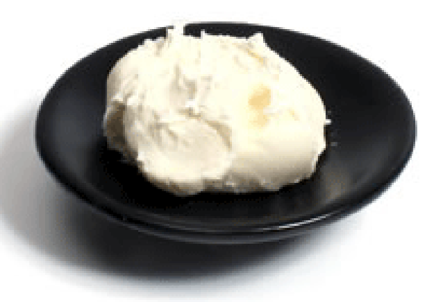 Mascarpone spooned on a black saucer