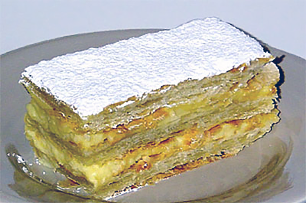 Millefeuille cake served on a smoked glass plate