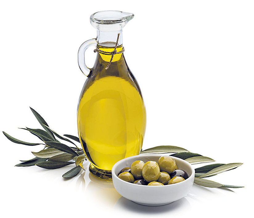 Olive oil in pouring jug shown with olives and olive branch