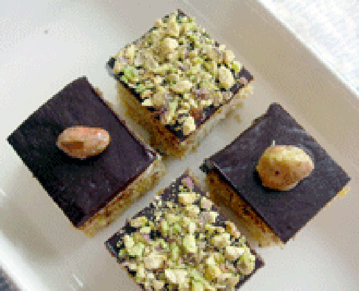 Four Petit Fours arranged on a plate