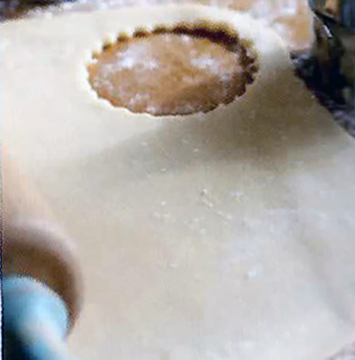 Shortcrust pastry rolled out on a work surface and with a circle cut out