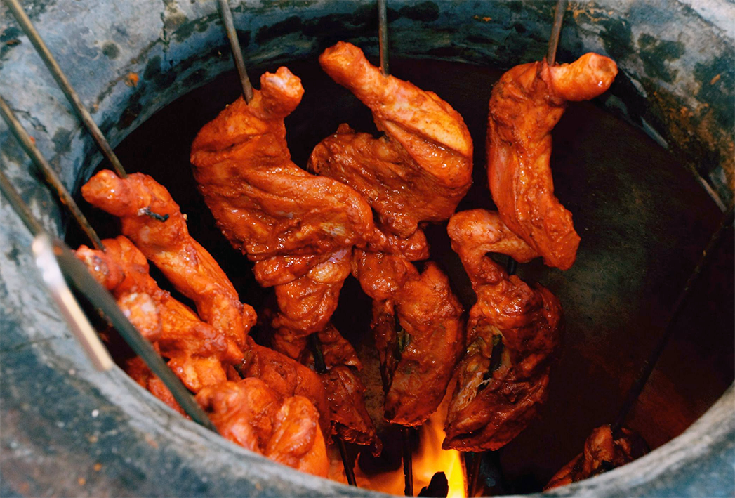 Tandoori chicken prepared in a traditional tandoor oven
