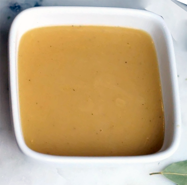 Veloute sauce in a white bowl