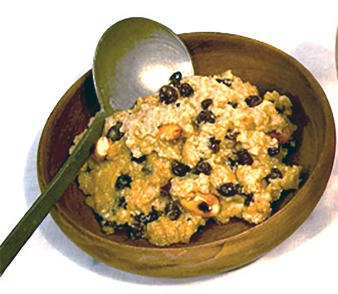 whitepot baked rice pudding with currants in a wooden bowl