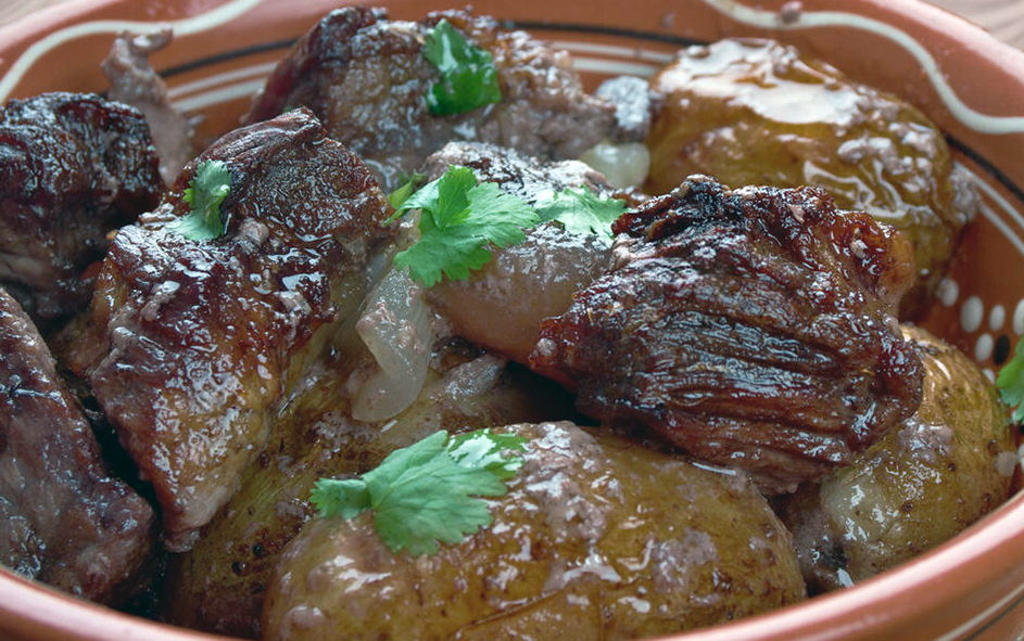 pork ribs marinated in red wine in an earthenware dish