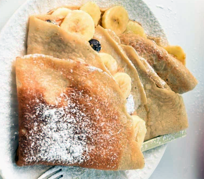 folded banana crepes with a sliced banana filling