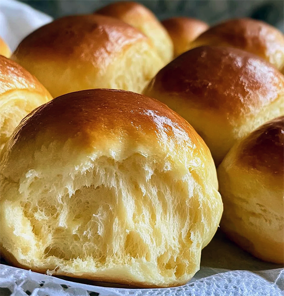 Amish soft yeasted dinner rolls in a cloth-lined basket
