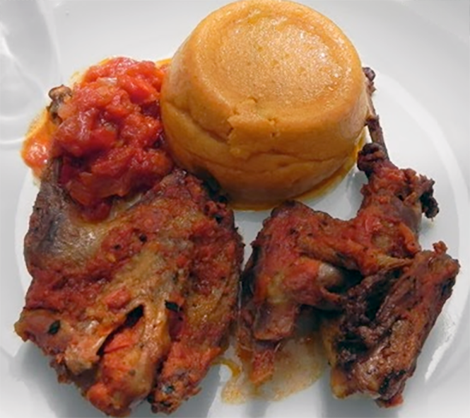 fried chicken pieces served with a thick cornmeal porridge turned out onto the plate