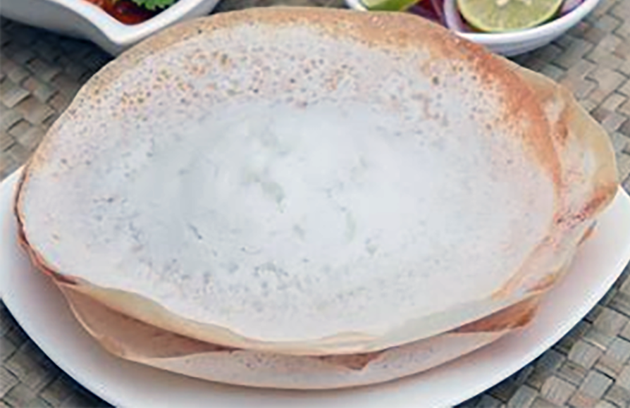 Sri Lankan appa (hopper) pancakes stacked on a plate</al>