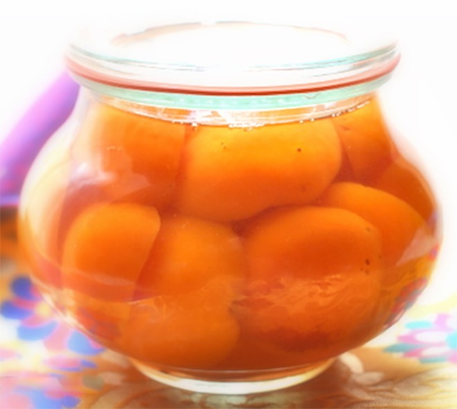 apricots preserved in brandy in a glass jar