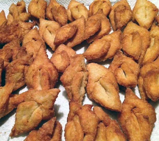 fried atwemo or twisted cakes draining on kitchen paper