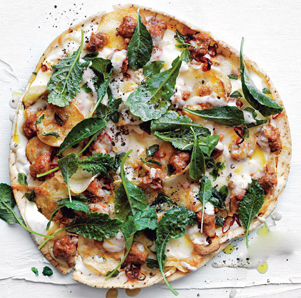 rustic aubergine and lamb pizza garnished with mint leaves