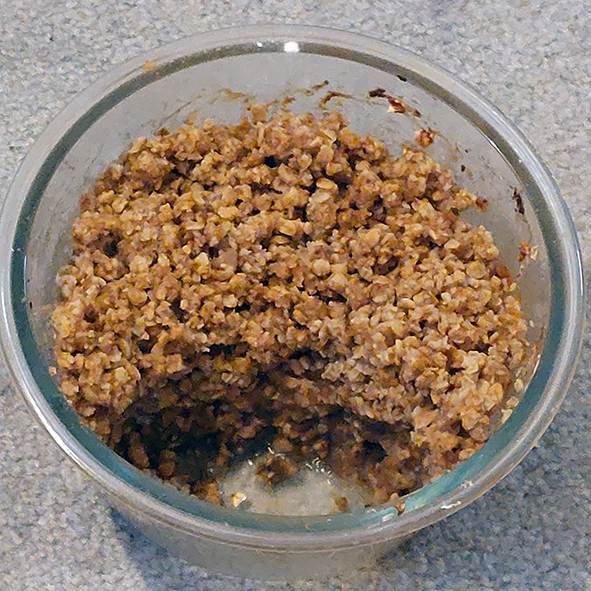 banana and chestnut crumble in a bowl with portion removed to reveal the filling
