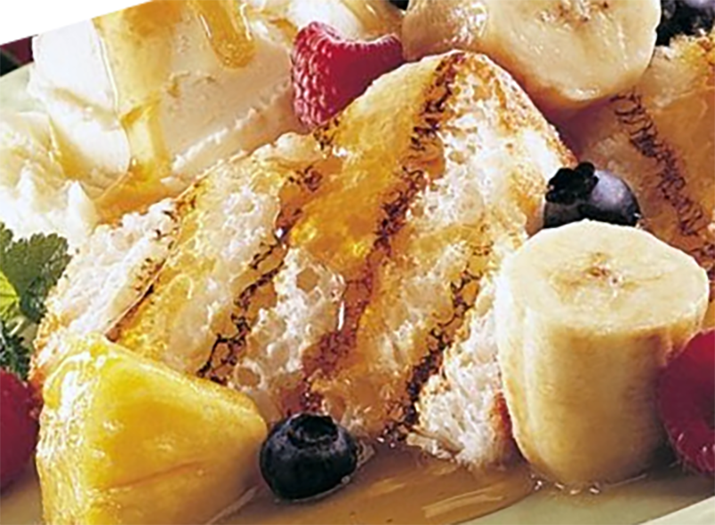 barbecued angel food cake served with mixed fruit and syrup