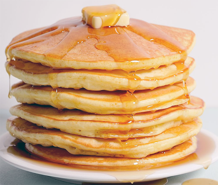 stack of quick mix pancakes drizzled with syrup