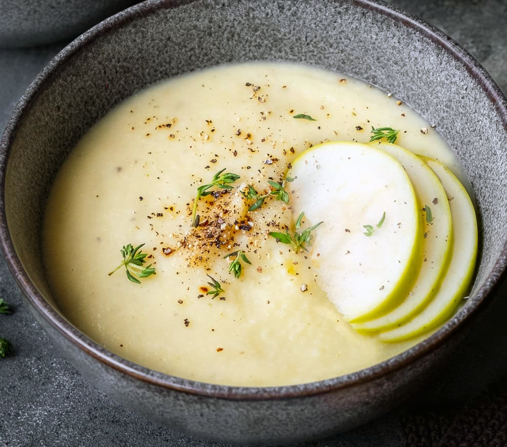 apple soup in a bowl garnished with sliced apples