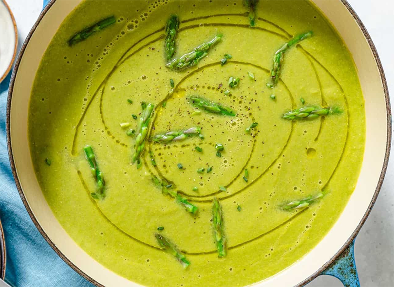 greens and asparagus tips soup served with a drizzle of olive oil