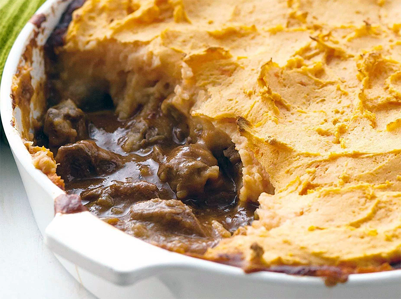 sliced beef in gravy with mashed potato topping