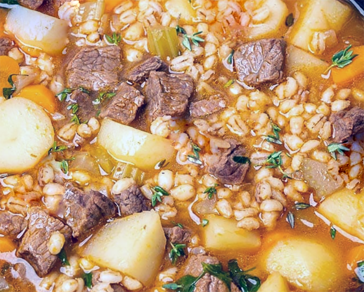 beef, pearl barley and potato soup in a stock pot