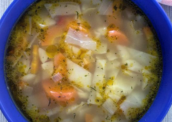 cabbage soup with carrots and onion served in a bowl