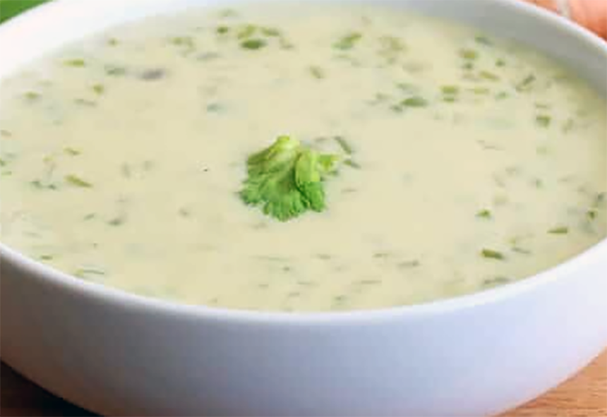 celery cream soup topped with a celery leaf