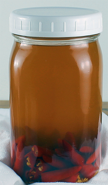 chilli vinegar maturing in a jar