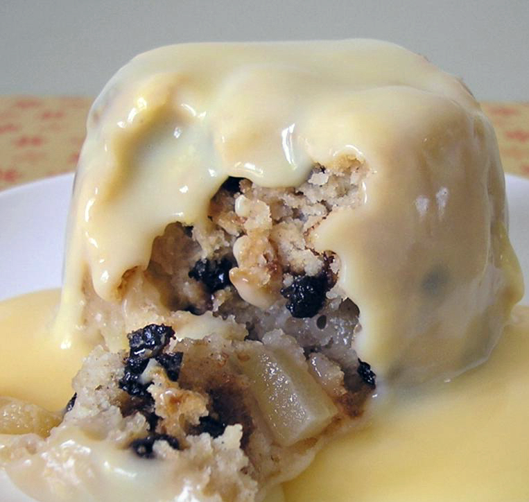 Mini Delhi suet pudding served on a plate with white sauce