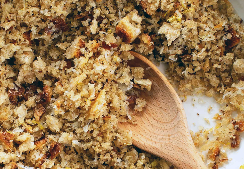 fried breadcrumbs in a bowl with a wooden spoon