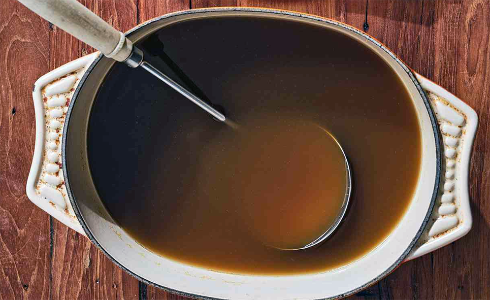 gravy stock in a dish with a ladle