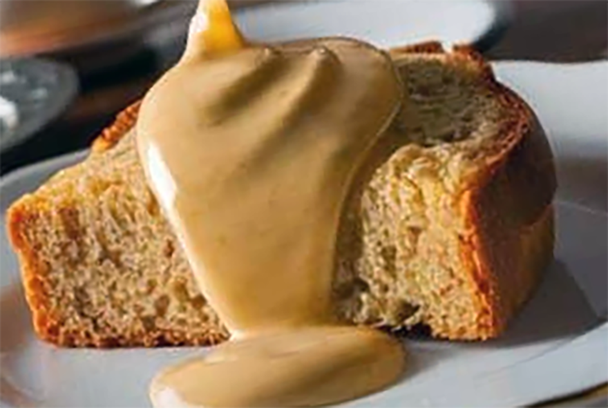 rum butter sauce poured over a cake