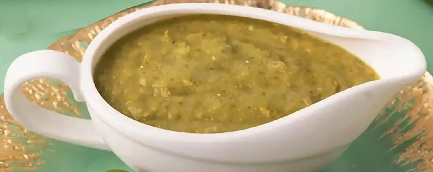 green bechamel sauce with parsley in a sauce boat