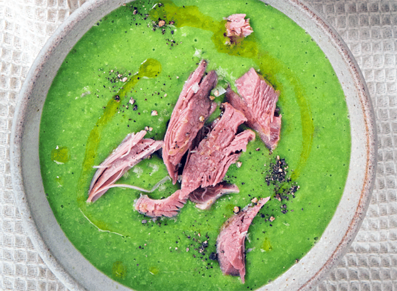 pea soup with spinach greening topped with chopped ham