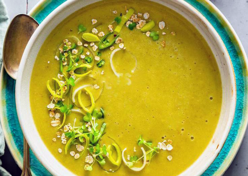 leek and oatmeal soup in a bowl garnished with chopped leek