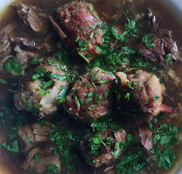 mock turtle soup with meatballs garnished with chopped parsley