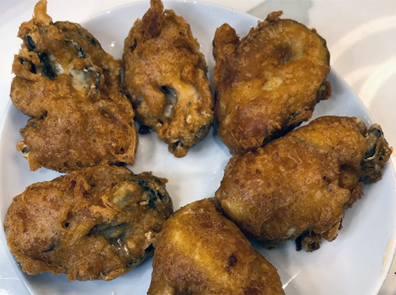 oysters fried in batter arranged on a plate