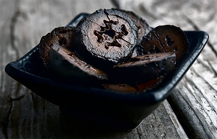 sliced pickled black walnuts in a small bowl