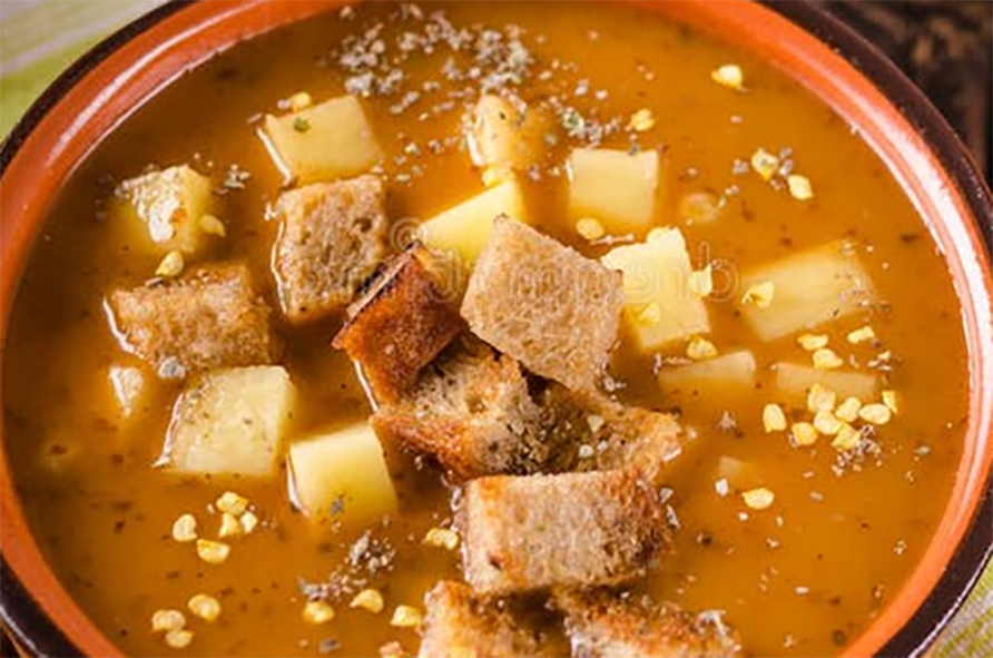 beef and potato soup topped with croutons