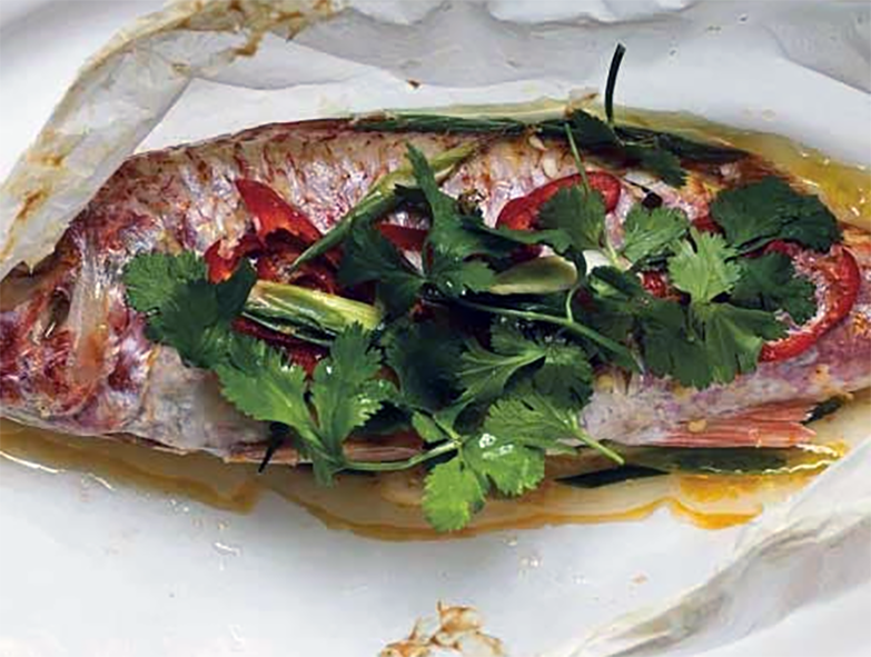 red mullet baked en papillote topped with fresh herbs