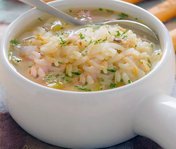 rice soup in a white stock base served in a bowl
