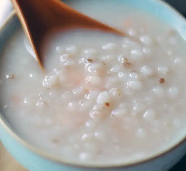 sago soup in a bowl with a wooden spoon