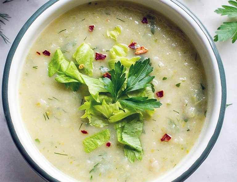 creamy flamande soup served garnished with celery leaves
