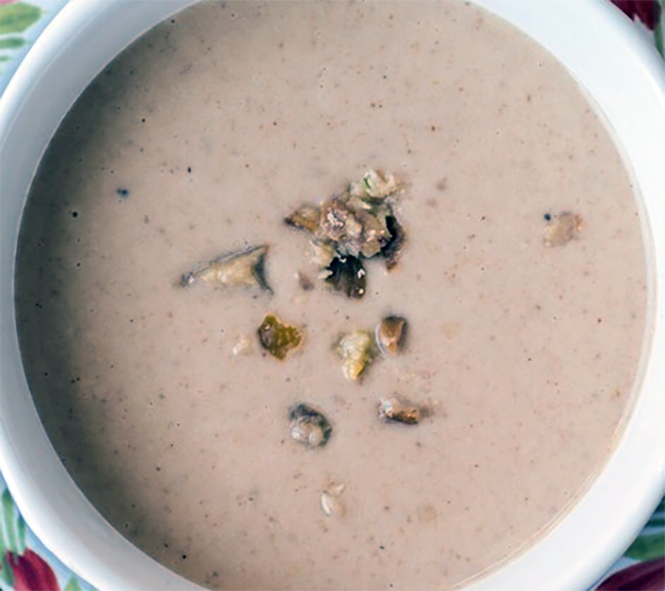cream of chestnut soup in a bowl topped with chestnut pieces