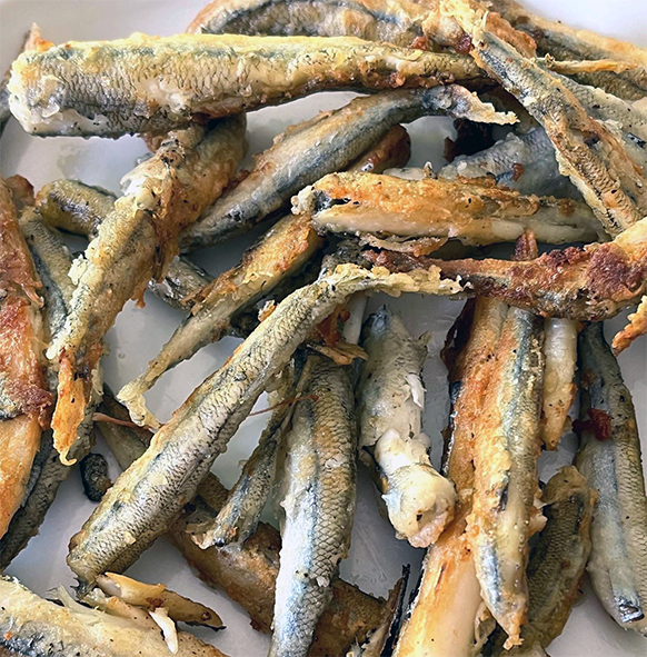 baked smelt arranged on a plate